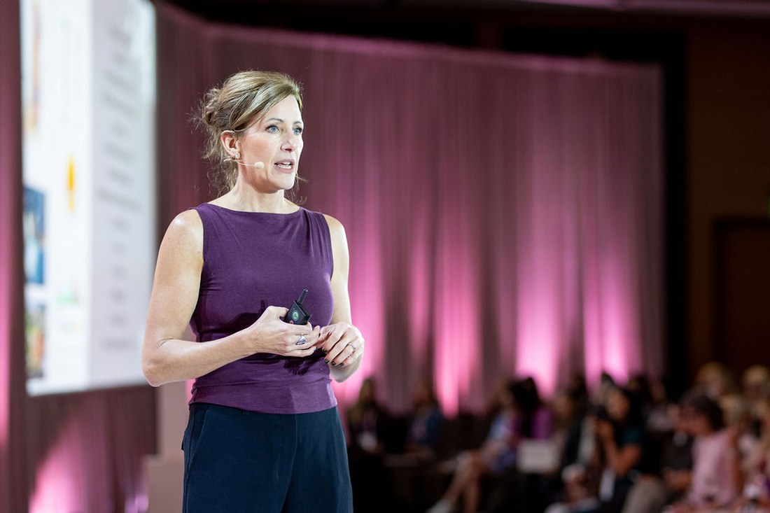 Kim speaking to a room of women