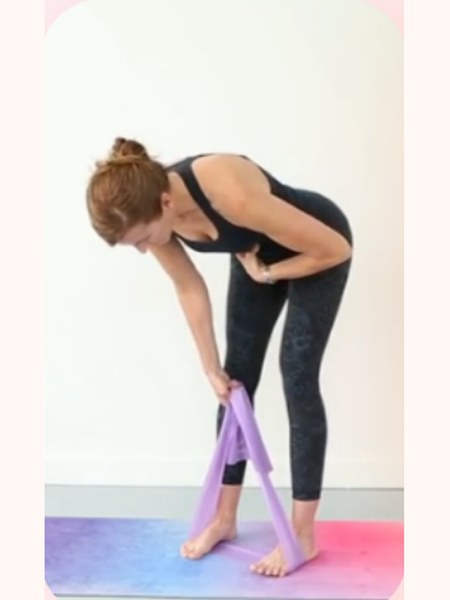 Hinging forward with a resistance band underfoot to build functional strength
